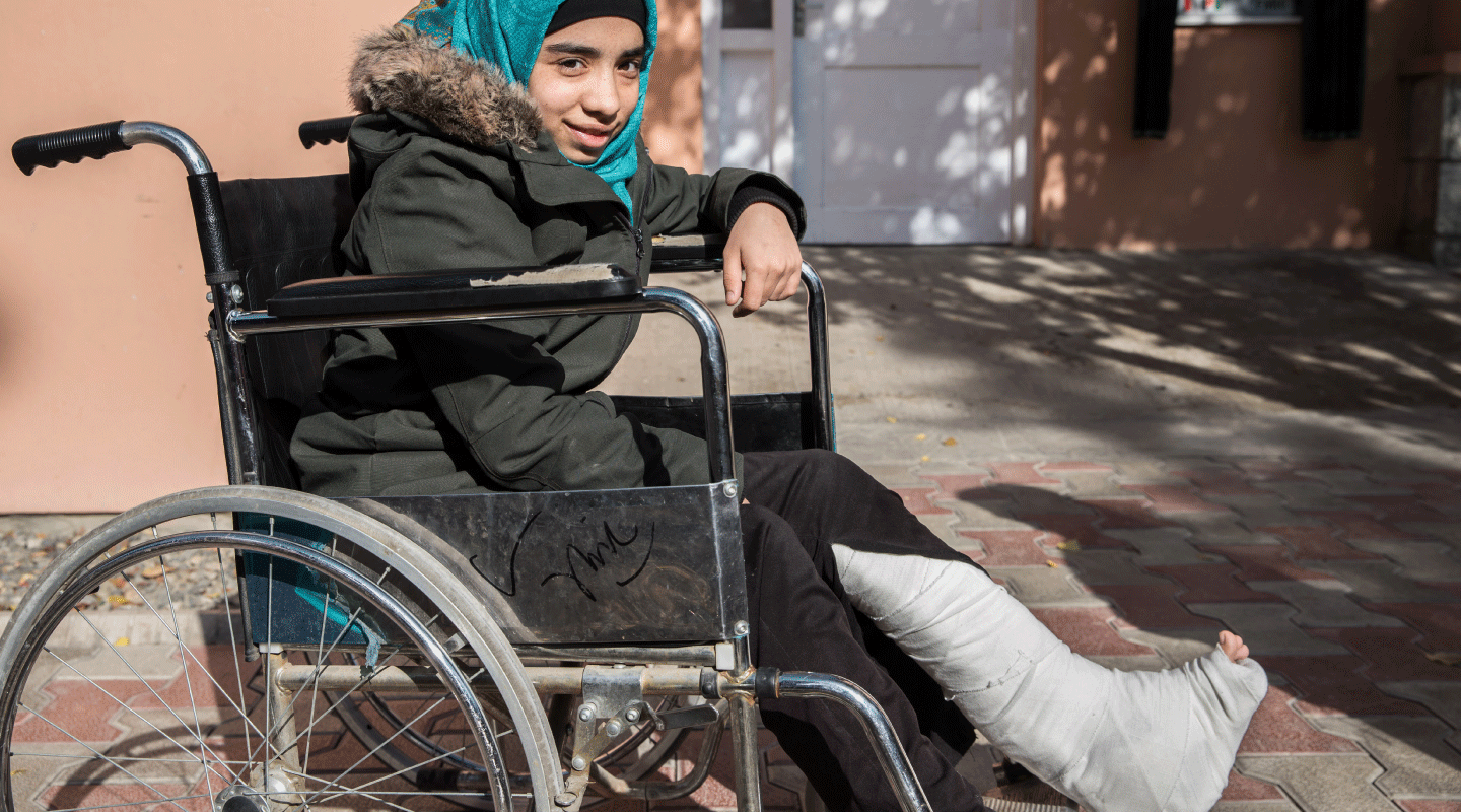 A father with his daughter at the IMFE in Kabul